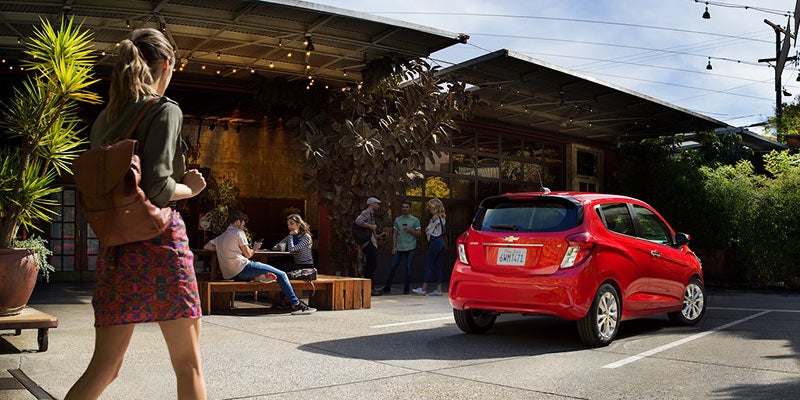 Red car parked besides cafe